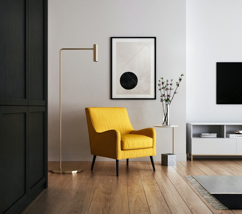 Staged living room with a yellow armchair and wood floors